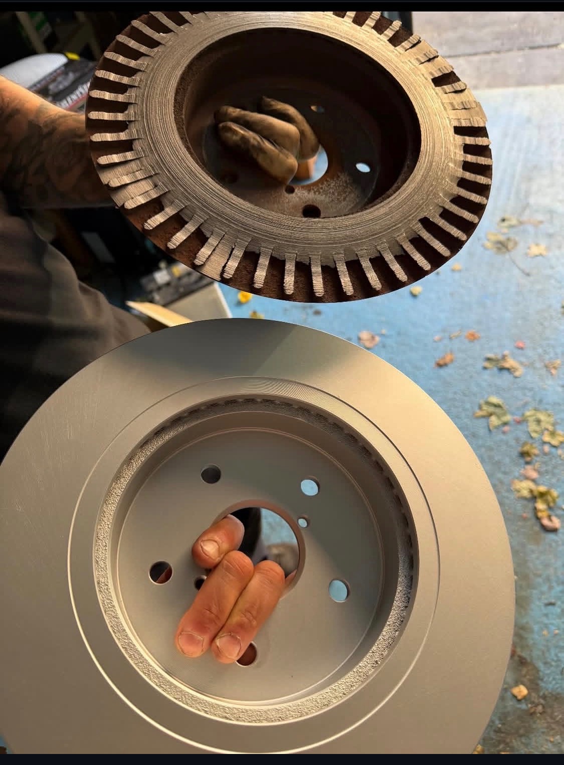 Close-up of a worn brake rotor evaluated for brake pad and rotor replacement